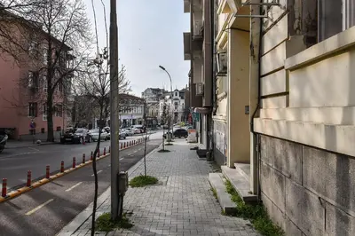 a city street with a sidewalk next to a building at Budget studio in Varna center unde roof in Varna City