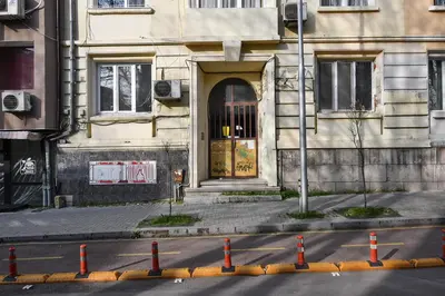 a building with a door on the side of a street at Budget studio in Varna center unde roof in Varna City