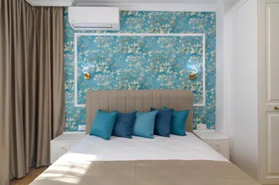 a bedroom with a bed with a blue wall at ЛУКС НА МОРЕ Luxury apartment in downtown with garage in Varna City