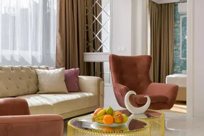 a living room with a couch and a table with fruit on it at ЛУКС НА МОРЕ Luxury apartment in downtown with garage in Varna City