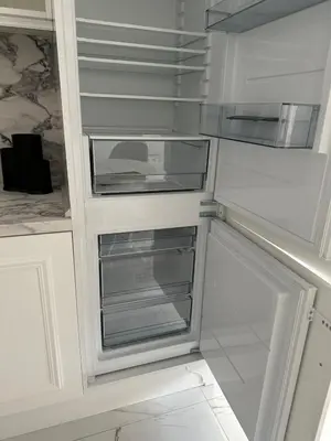 an empty refrigerator with its door open in a kitchen at ЛУКС НА МОРЕ Luxury apartment in downtown with garage in Varna City