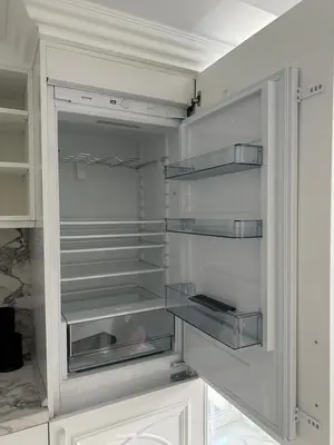 a white refrigerator with its door open in a kitchen at ЛУКС НА МОРЕ Luxury apartment in downtown with garage in Varna City
