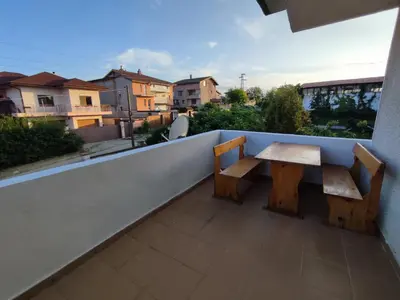 a table and benches on a balcony with a view at Longoz in Bliznatsi
