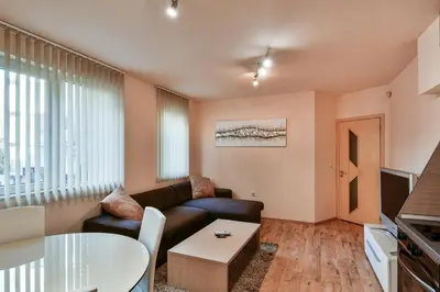 a living room with a couch and a table at Budget 1BR flat downtown Varna in Varna City