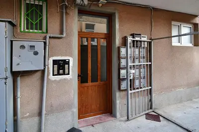 a building with a wooden door and a gate at Budget 1BR flat downtown Varna in Varna City