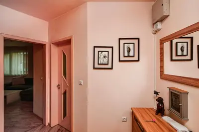 a room with a hallway with a door and pictures on the wall at Budget 1BR flat downtown Varna in Varna City