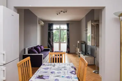 a living room with a table and a couch at Super Central flat in Varna in Varna City