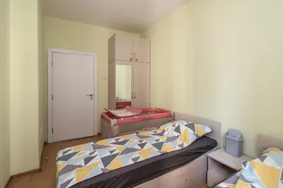 a small bedroom with a bed and a closet at Super Central flat in Varna in Varna City