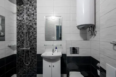 a bathroom with a sink and a shower and a toilet at Super Central flat in Varna in Varna City