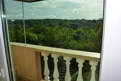 a balcony with a view of the trees at Семеен Хотел Детелини in Primorsko