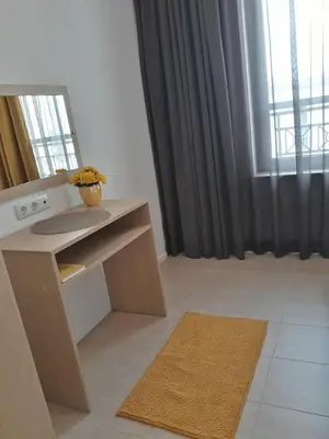 a room with a desk and a mirror and a window at Апартамент Orange в местност Каваци, Созопол in Sozopol