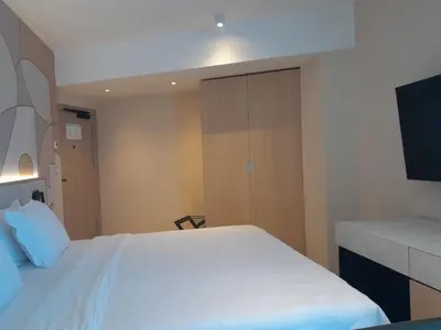 a bedroom with a white bed and a tv at Hotel Zenith in Sunny Beach