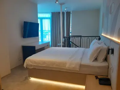 a bedroom with a bed with a light on it at Hotel Zenith in Sunny Beach