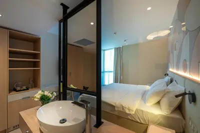 a bathroom with a bed and a sink and a mirror at Hotel Zenith in Sunny Beach