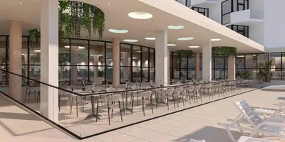 a cafeteria with tables and chairs in a building at Hotel Zenith in Sunny Beach