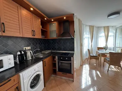 a kitchen with a washer and dryer in a room at Atia Resort in Chernomorets