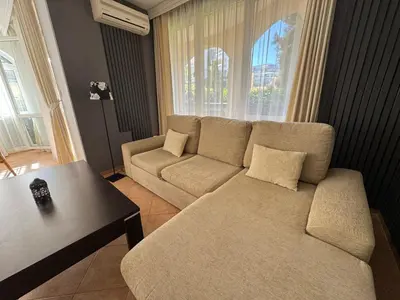 a living room with a couch and a table at Atia Resort in Chernomorets