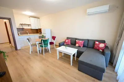 a living room with a couch and a table at Kristin Palace in Obzor