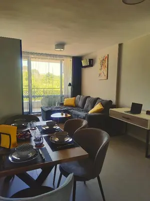 a living room with a couch and a table and chairs at Blue Heaven Apartment Kavaci Sozopol in Sozopol