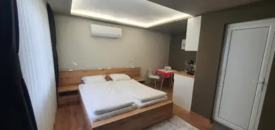 a small room with a bed and a table at KALI GUEST ROOM in Varna City