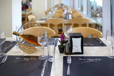 a table with a bottle of wine and glasses on it at Grand Hotel Nirvana - All Inclusive & Free Beach Access in Sunny Beach