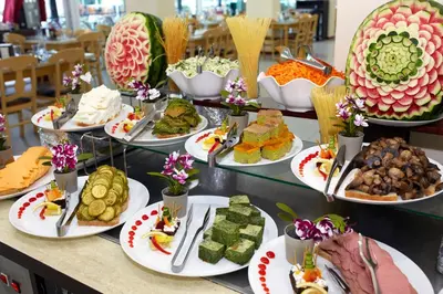 a table topped with lots of different types of food at Grand Hotel Nirvana - All Inclusive & Free Beach Access in Sunny Beach