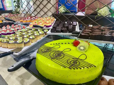 a yellow cake sitting on top of a table with other desserts at Grand Hotel Nirvana - All Inclusive & Free Beach Access in Sunny Beach