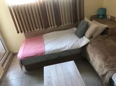 a small bed in a room with a radiator at Cute Studio Apt, Pollo Resort in Sunny Beach