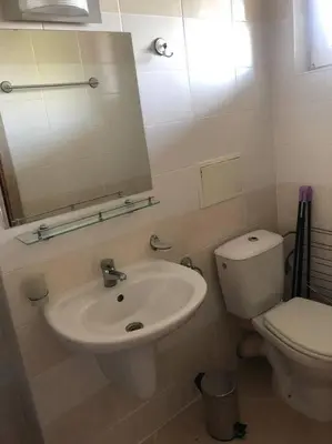 a bathroom with a sink and a toilet and a mirror at Cute Studio Apt, Pollo Resort in Sunny Beach