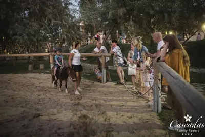 a group of people standing around a fence with a horse at Luxurious Studio Apt,4* Cascadas in Sunny Beach