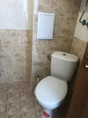 a bathroom with a white toilet in a room at Snug Studio Apt, Sunny Day 6 in Tŭnkovo
