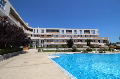 a hotel with a swimming pool in front of a building at Doris Beach studio D09 and studio D10 in Burgas City
