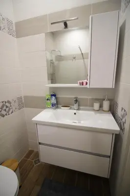 a bathroom with a white sink and a mirror at Doris Beach studio D09 and studio D10 in Burgas City