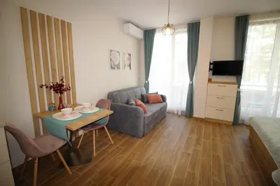a living room with a couch and a table at Doris Beach studio D09 and studio D10 in Burgas City