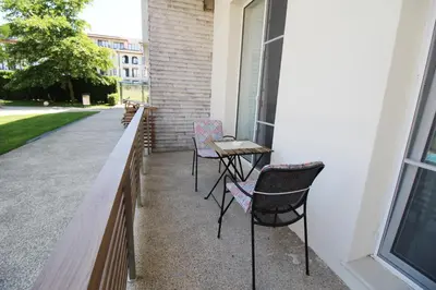 a patio with two chairs and a table on the side of a building at Doris Beach studio D09 and studio D10 in Burgas City