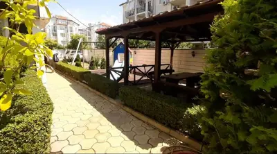 a walkway with a pavilion next to a building at Апартамент за гости Магнолия Резиденс in Sunny Beach