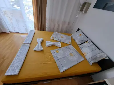 a table with ties and napkins on it at Апартамент за гости Магнолия Резиденс in Sunny Beach