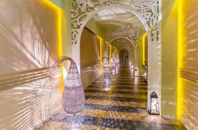 a hallway of a building with an archway and a hallwayngth at Reina Apart Barcelo Beach in Sunny Beach