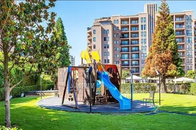 a playground in a park with a slide at Reina Apart Barcelo Beach in Sunny Beach
