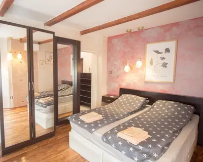 a bedroom with a bed and a mirror at Aleks Holiday-center,sea,parking in Burgas City