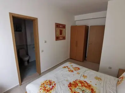 a bedroom with a bed and a bathroom with a mirror at Homely, 2 Bed Apt, 4* Vineyards in Kableshkovo