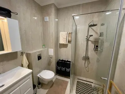 a bathroom with a shower and a toilet at Luxury Penthouse Apartments at Valencia Gardens in Burgas City