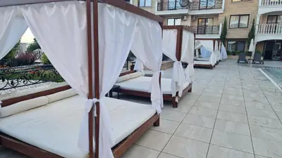 a row of beds sitting on a patio at Luxury Penthouse Apartments at Valencia Gardens in Burgas City