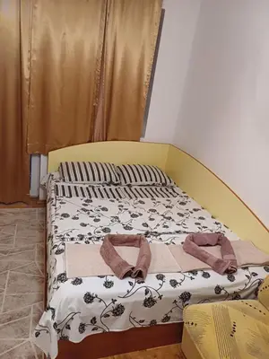 a bed with two towels on it in a room at ПРИНЦЕС in Burgas City