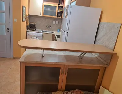 a kitchen with a counter and a refrigerator at ПРИНЦЕС in Burgas City