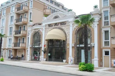 a building with a palm tree in front of it at Plush, 1 Bed Apt, Dawn Park D in Sunny Beach