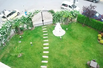 an aerial view of a backyard with a lawn with a pathway at Plush, 1 Bed Apt, Dawn Park D in Sunny Beach