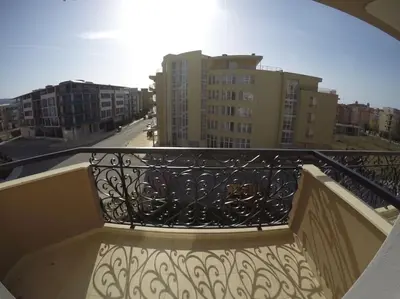a balcony with a wrought iron railing and buildings at Plush, 1 Bed Apt, Dawn Park D in Sunny Beach
