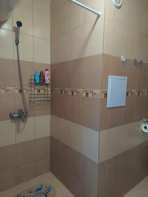 a bathroom with a shower with a glass door at Солнечный берег Grand Kamelia in Sunny Beach