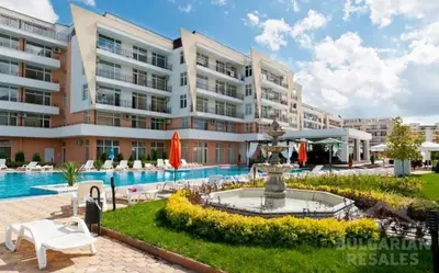 a hotel with a fountain in front of a building at Солнечный берег Grand Kamelia in Sunny Beach